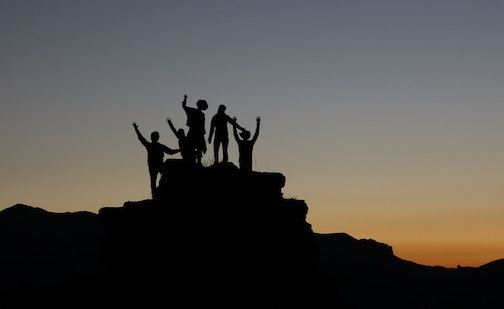 Team celebrating on a mountaintop